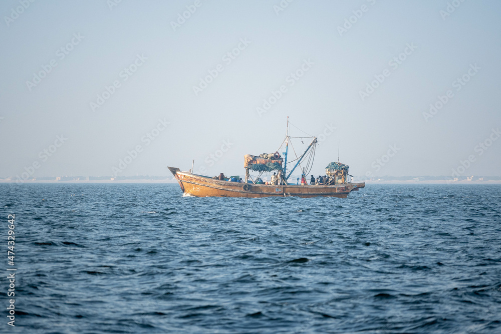 Small Fishing Boat in the Sea during fishing.  Karachi, Pakistan.