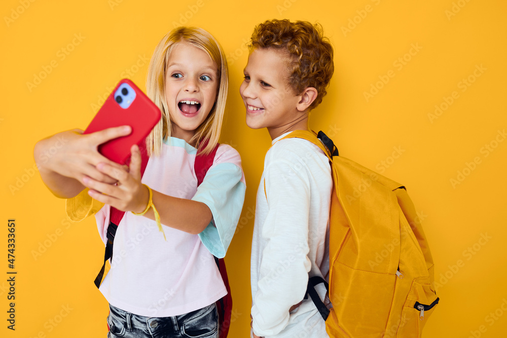 cute kids looking at the phone entertainment communication isolated background cute kids looking at the phone entertainment communication isolated background