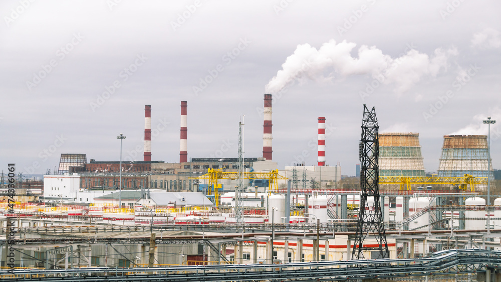 An oil and gas processing plant. Factory buildings, production pipes, railway tanks. Panorama of a large factory.	