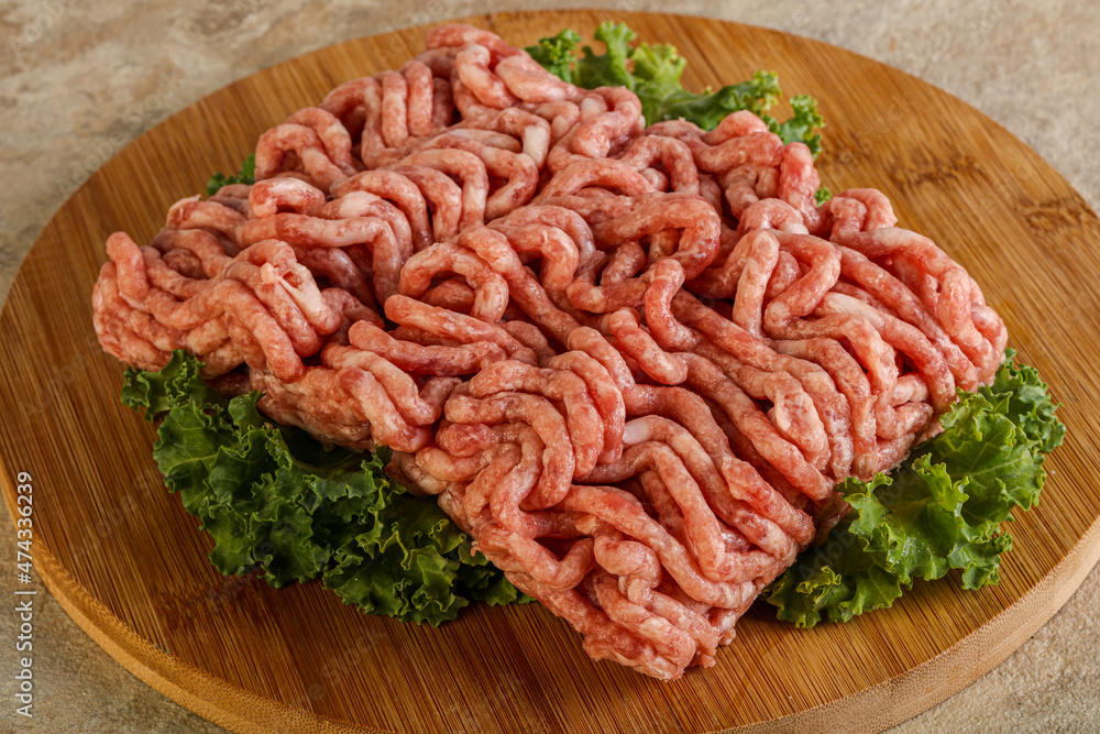 Raw pork minced meat over board Raw pork minced meat over board
