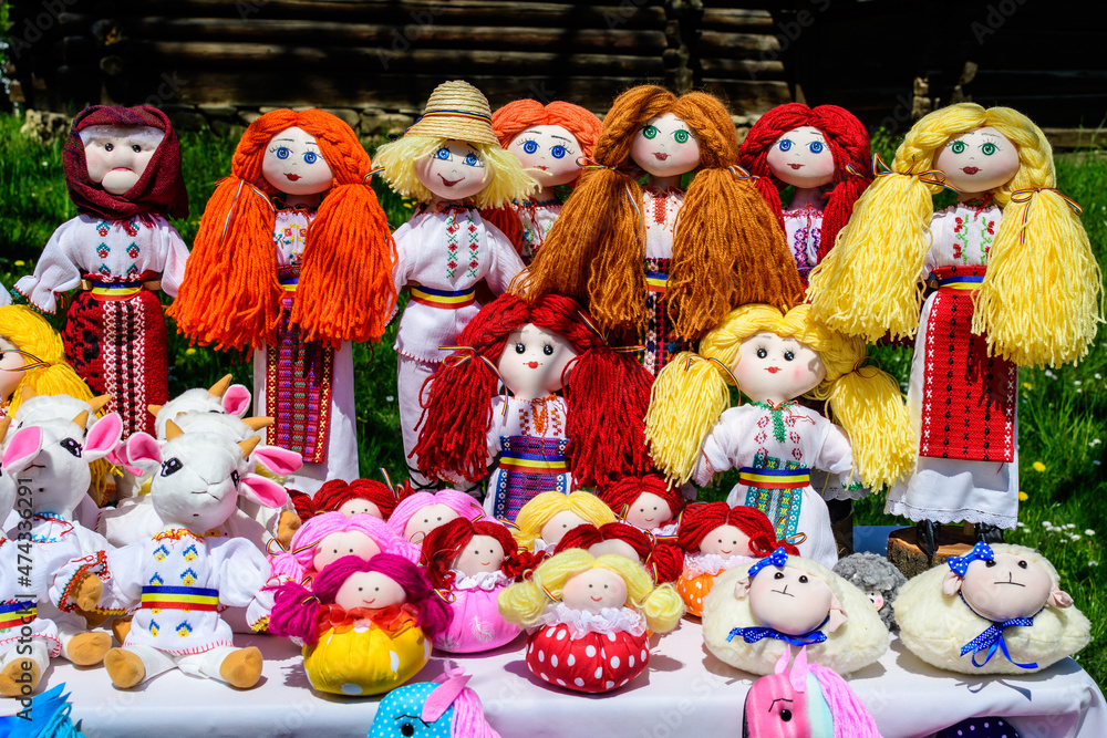 Group of colourful textile traditional hand made decorations, dolls and toys for children, available for sale at a traditional weekend market in a village near Bucharest, Romania. Group of colourful textile traditional hand made decorations, dolls and toys for children, available for sale at a traditional weekend market in a village near Bucharest, Romania.
