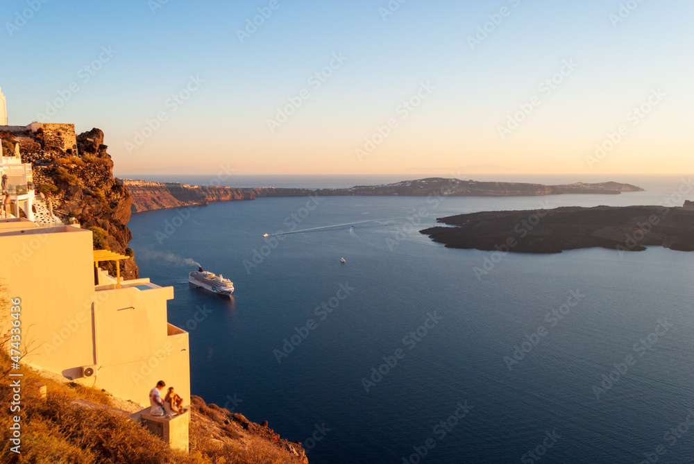 View of the bay of Santorini and the cruise ship during sunset