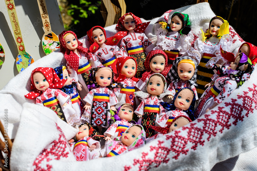 Group of colourful textile traditional hand made decorations, dolls and  toys for children, available for sale at a traditional weekend market in a village near Bucharest, Romania.