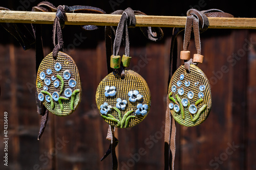 Group of colourful hand painted mixed necklaces and suvenirs displayed for sale at a traditional weekend market in Bucharest, Romania. photo