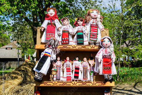 Group of colourful textile traditional hand made decorations, dolls and toys for children, available for sale at a traditional weekend market in a village near Bucharest, Romania.