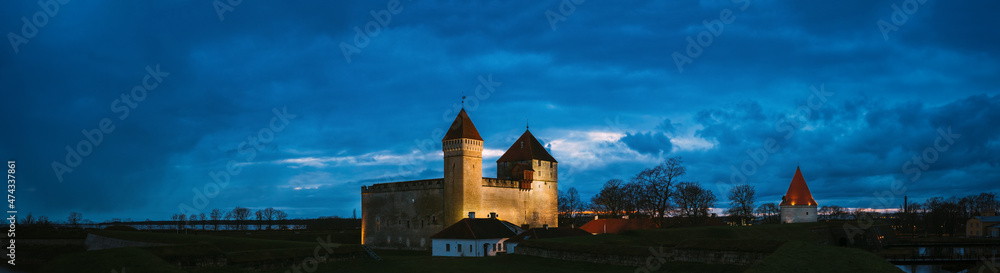 Kuressaare, Saaremaa Island, Estonia. Episcopal Castle In Evening Blue Hour Night. Traditional Medieval Architecture, Famous Attraction Landmark. Old Tower. Panorama, panoramic view Copy space