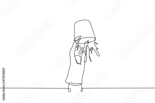man is pouring large bucket of water on himself - one line drawing vector. hardening concept, ice bucket challenge, water treatments, cold shower
