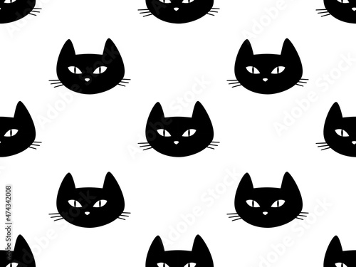 Seamless pattern with muzzles of black cats on a white background.