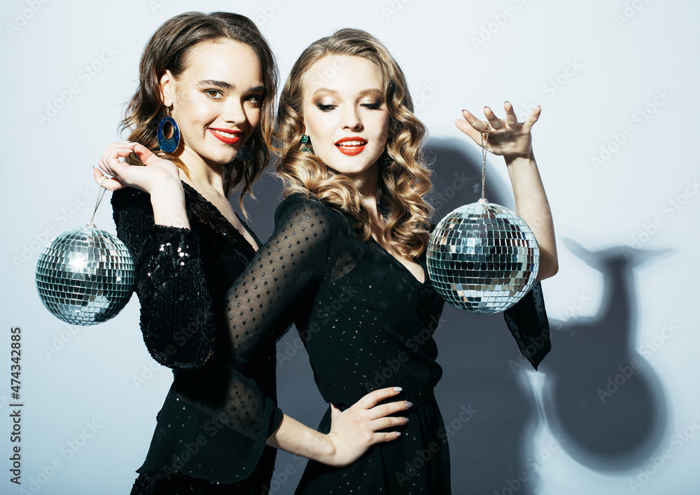 Two Party women in black dress with disco balls Two Party women in black dress with disco balls