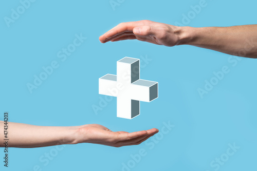 Hand hold 3D plus icon, man hold in hand offer positive thing such as profit, benefits, development, CSR represented by plus sign.The hand shows the plus sign