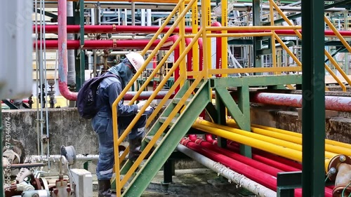 Wallpaper Mural Male worker inspection at steel long pipes and pipe elbow in station oil factory during refinery valve of visual check record pipeline oil and gas industry. Torontodigital.ca