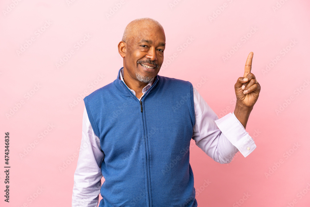 Cuban senior isolated on pink background pointing up a great idea Cuban senior isolated on pink background pointing up a great idea