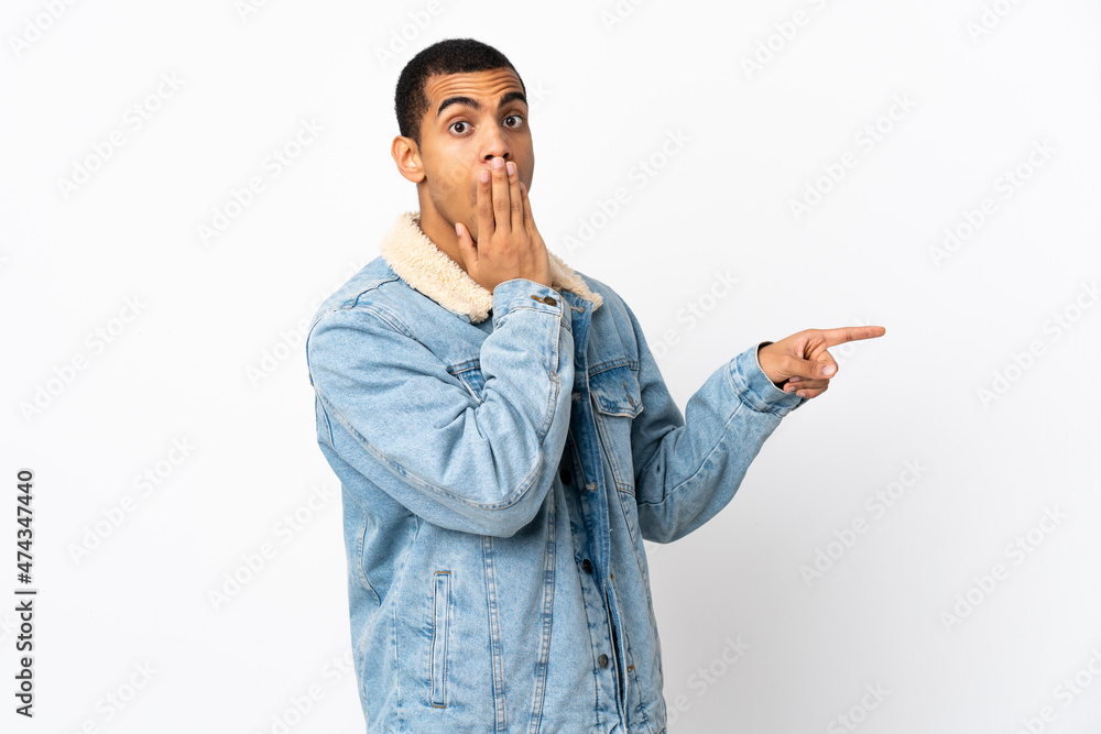 African American man over isolated white background with surprise expression while pointing side African American man over isolated white background with surprise expression while pointing side