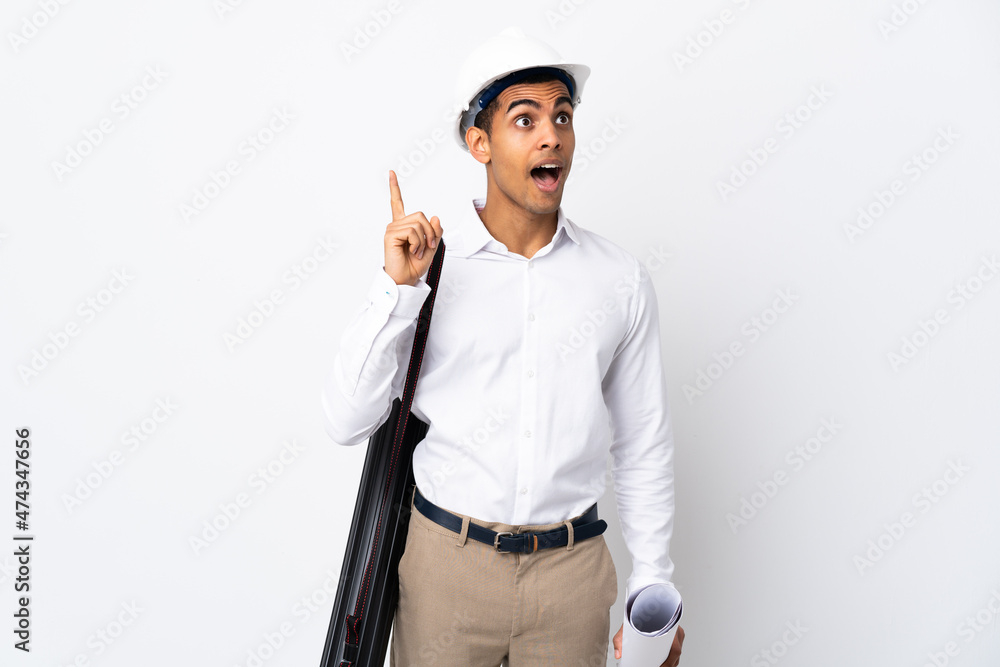 African American architect man with helmet and holding blueprints over isolated white background _ intending to realizes the solution while lifting a finger up African American architect man with helmet and holding blueprints over isolated white background _ intending to realizes the solution while lifting a finger up