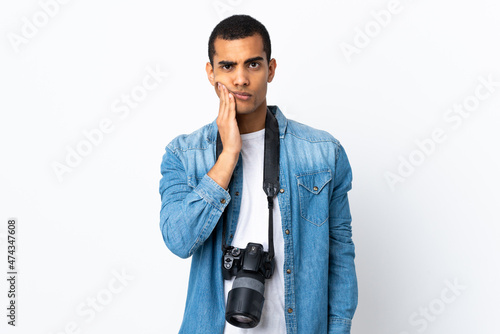 Young African American photographer man over isolated white background unhappy and frustrated