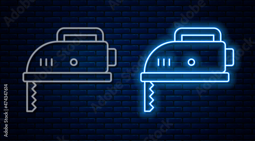 Glowing neon line Electric jigsaw with steel sharp blade icon isolated on brick wall background. Power tool for woodwork. Vector
