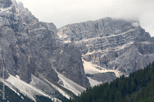 Italian Dolomites mountains covered with low clouds