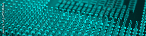 Computer processor close-up. Turquoise tinted banner. Information technology teal headline. A pattern of contacts and semiconductors of a PC microprocessor. Macro