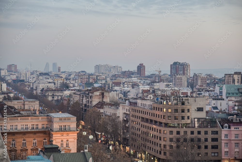 Belgrade pollution cityscape view with the grey sky above the city during the dusk at the end of the fall and start of the winter time casting the perfect sunset light for the capital city of Serbia