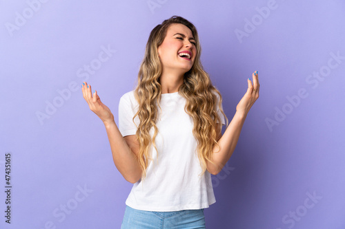 Young Brazilian woman isolated on purple background smiling a lot