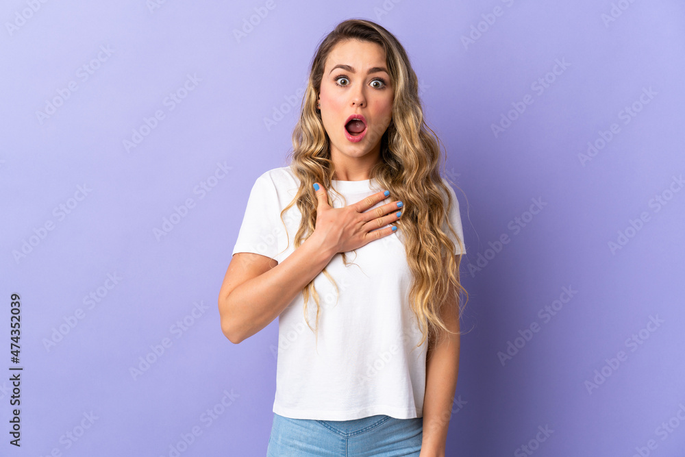 Young Brazilian woman isolated on purple background surprised and shocked while looking right Young Brazilian woman isolated on purple background surprised and shocked while looking right