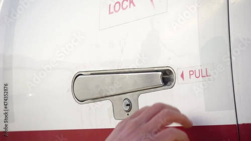 Opening the door of the jet that is red and white