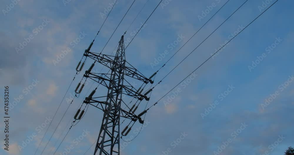 Tracking shot past an iron power line with wires against the background of beautiful clouds and blue sky. With copy spase. Tracking shot past an iron power line with wires against the background of beautiful clouds and blue sky. With copy spase.
