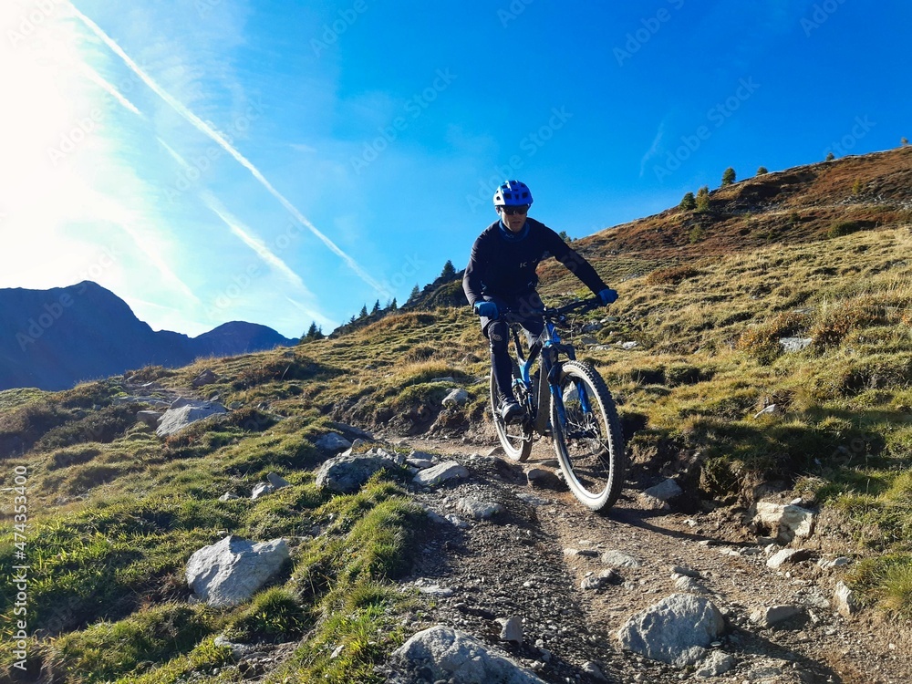 Person rides enduro bike with much action and fun. Davos, Grison, Swiss Alps, Switzerland