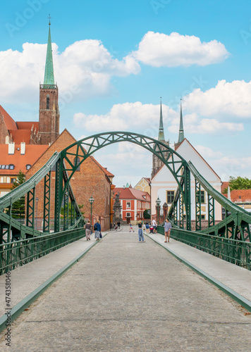 Fototapeta Naklejka Na Ścianę i Meble -  Wroclaw, Poland - crossed by the Oder River, Wroclaw displays a large number of colorful bridges, which are a main landmark of the town. Here in particular a typical iron bridge