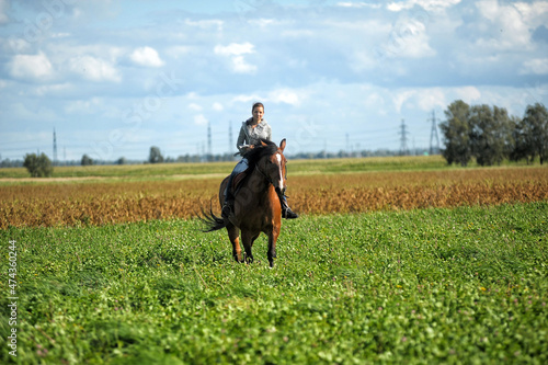 teenager girl with a horse in the field © Evdoha