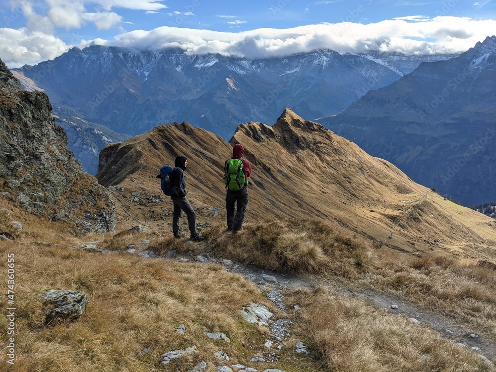 Friendship. Hiking with friends in a beautiful mountain landscape above Glarus .Autumn hike. discover the world together