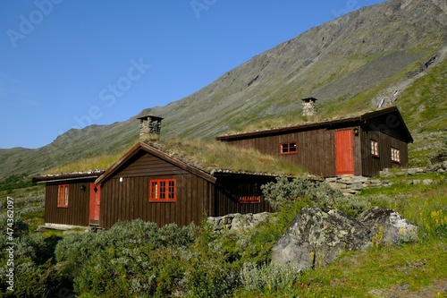 Traditional wooden turf houses in the Norwegian mountains.  Spiterstulen - Norwegian tourist hostel located in Jotunheimen Mountains, in Visdalen valley, on Visa River. Jotunheimen National Park photo