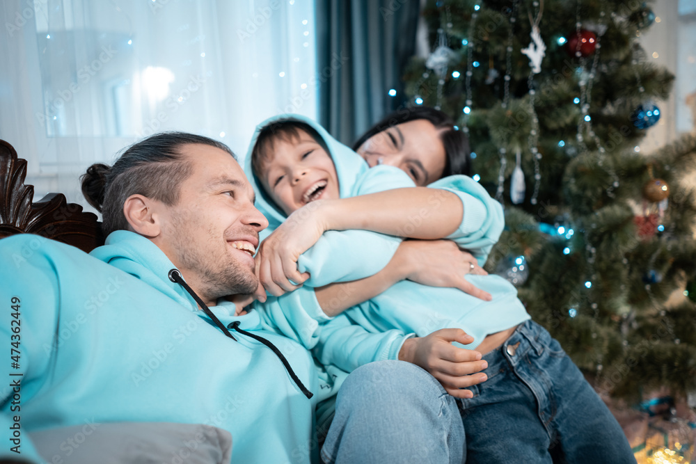 happy family with mother father and son have fun on christmas decorating tree happy family with mother father and son have fun on christmas decorating tree