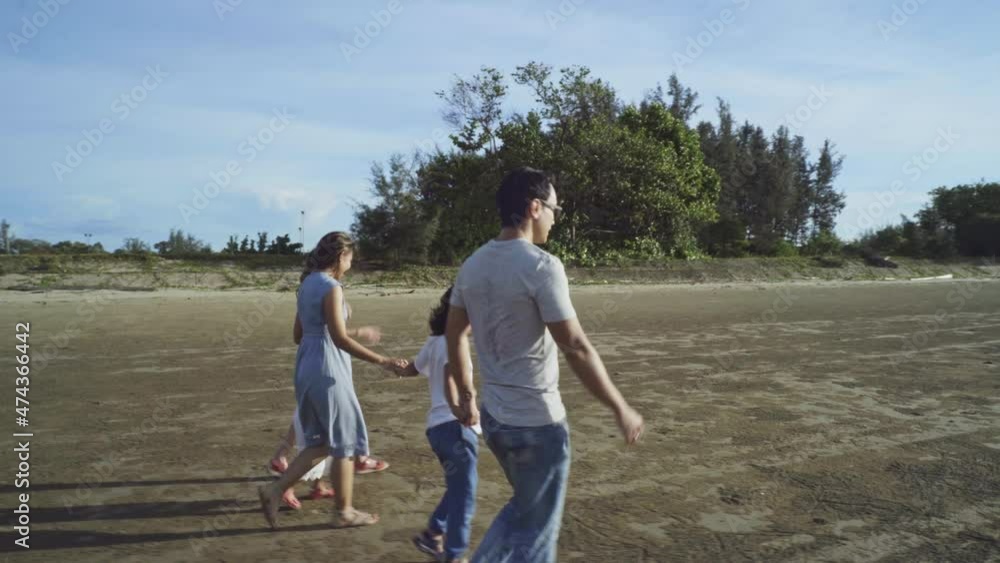 family, leisure and people concept-back view of young active parents with three daughters - enjoying summer vacation together. Big asian happy family of five.Pleasure from nature and communication. family, leisure and people concept-back view of young active parents with three daughters - enjoying summer vacation together. Big asian happy family of five.Pleasure from nature and communication.