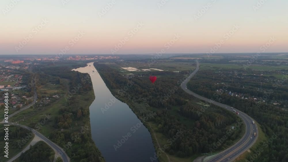 Aerial view Hot air balloon shape heart in sky over field in countryside, beautiful sky and sunset. Aerostat fly over countryside.Aerial footage 4K Aerial view Hot air balloon shape heart in sky over field in countryside, beautiful sky and sunset. Aerostat fly over countryside.Aerial footage 4K