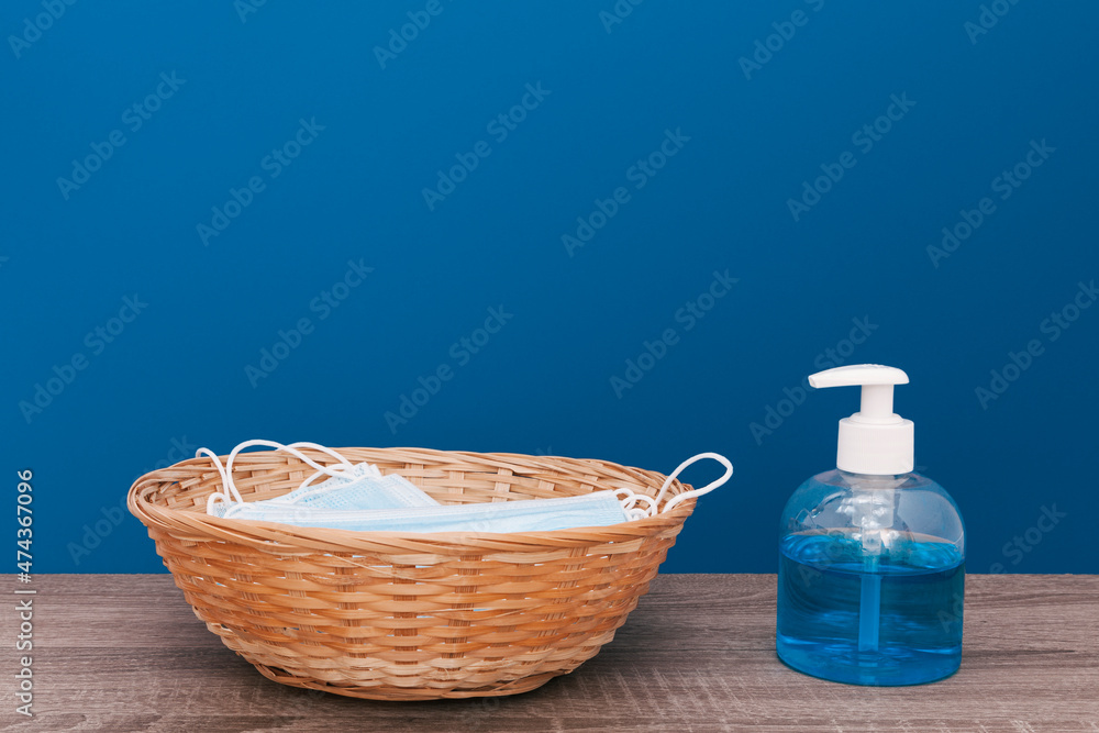 Hydroalcoholic gel dispenser and surgical masks in a basket Hydroalcoholic gel dispenser and surgical masks in a basket