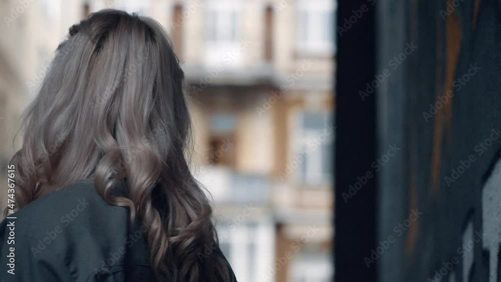 Blonde girl walking urban city landscape at daytime near modern architecture. Blonde girl walking urban city landscape at daytime near modern architecture.