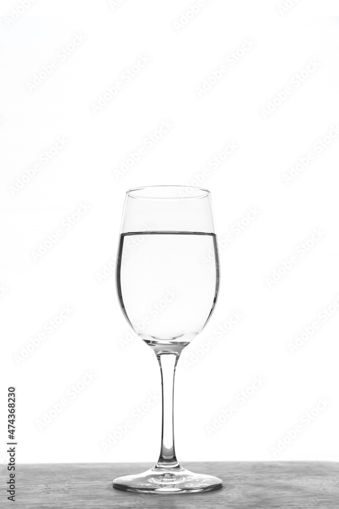 Vertical Glass of water isolated on white background.Transparent glass of water on light background