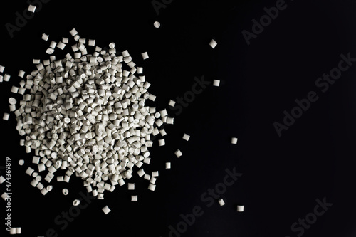 Many white, grey granules of polypropylene, polyamide. Background. Plastic and polymer industry, industry. Microplastic products.
