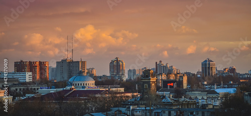 View from a height of the city at sunset. Evening Odessa overlooking the railway station. Dramatic sky over city streets. Aerial view panorama sunset city.