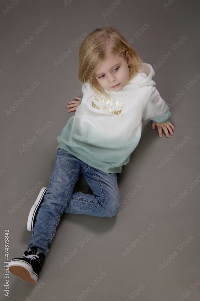Studio portrait of toddler girl in jeans and hoodie Studio portrait of toddler girl in jeans and hoodie