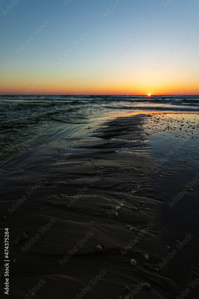 Sand textures on the beach in sunset light vertical