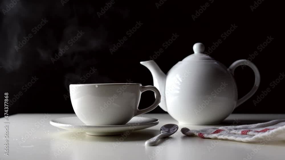 Hot water is poured into a cup of tea on a white table. High quality FullHD footage Hot water is poured into a cup of tea on a white table. High quality FullHD footage