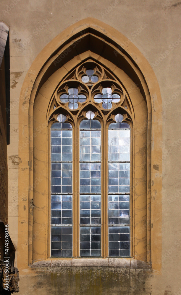 Pointed gothic window arch with tracery at St John church in the old town of Kitzingen, Franken region in Germany