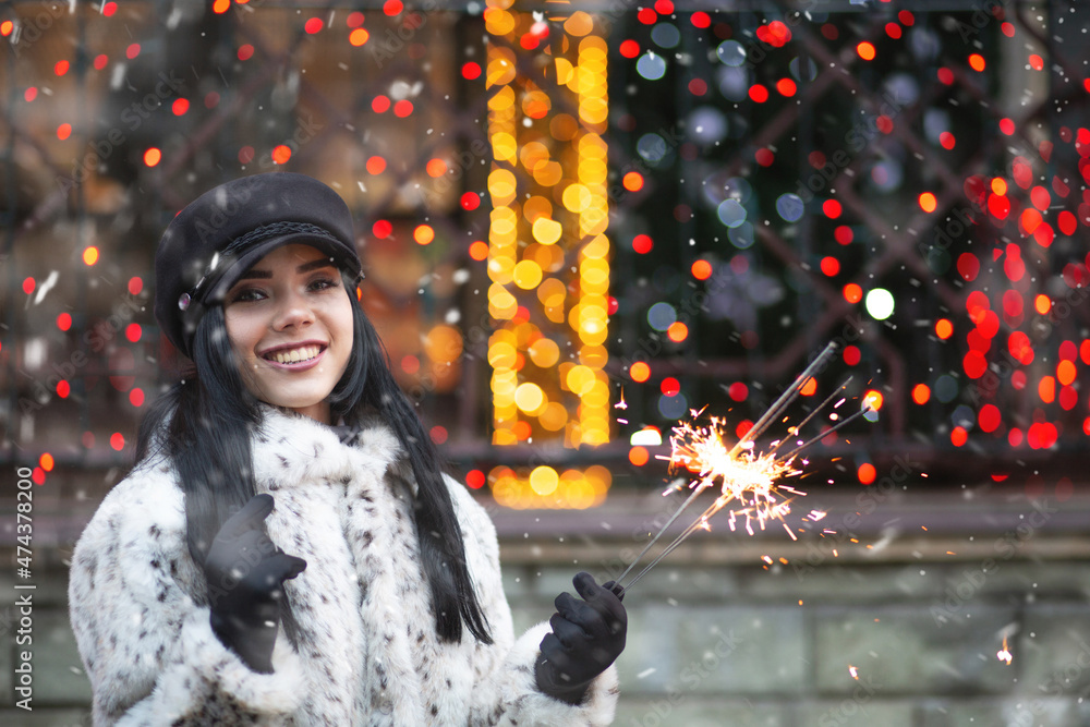 Charming lady enjoying winter holidays with sparklers Charming lady enjoying winter holidays with sparklers