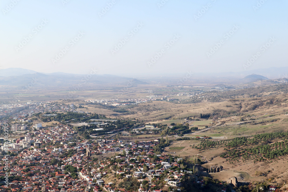 past and present - scenic view to the modern city Bergama in Turkey from ruins of ancient city Pergamon