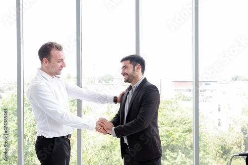 businessman and partnership handshaking in meeting room