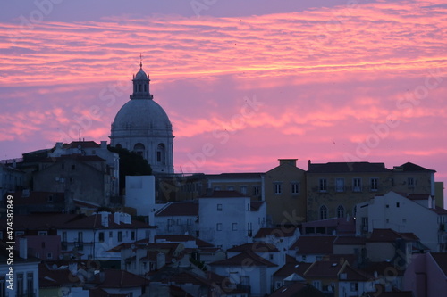 Cityscape Image of Lisbon, Portugal during dramatic sunrise.