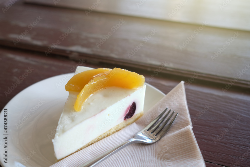 Fototapeta premium A slice of yogurt cake closeup on wooden table