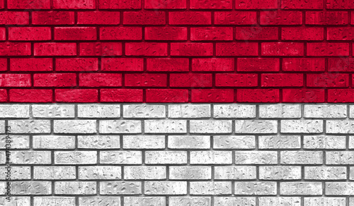 Monaco flag on a brick wall